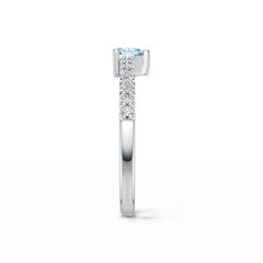 Silver ring with a blue gemstone and smaller diamonds on a white background